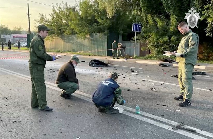 Investigators work at the site of a suspected car bomb attack that killed Darya Dugina, daughter of ultra-nationalist Russian ideologue Alexander Dugin, in the Moscow region, Russia August 21, 2022, in this still image taken from video.