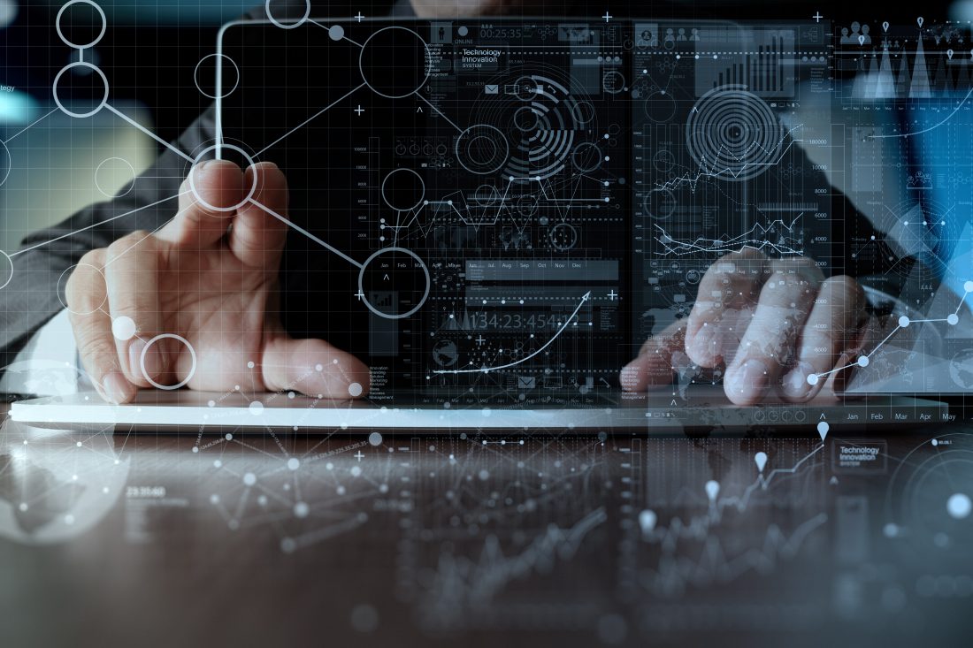 A person interacts with a laptop, overlaid with digital graphs and network diagrams. The scene conveys a futuristic, tech-driven atmosphere.