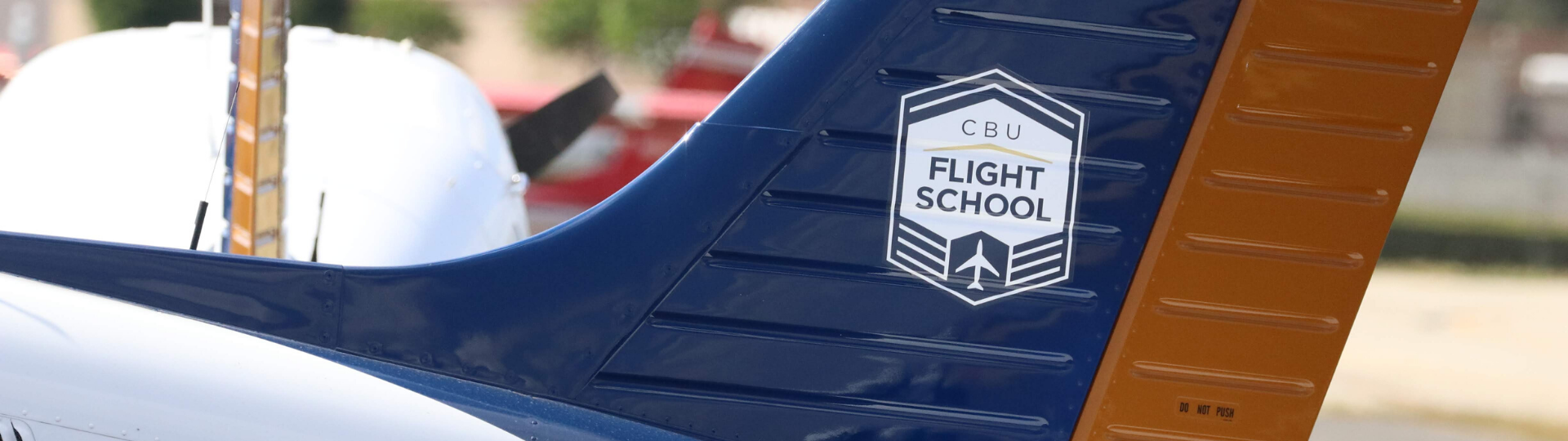 CBU plane that says "cbu flight school" on it