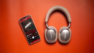 Bowers & Wilkins Px8 S2 headset next to Vivo X300 Pro with Spotify