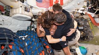 From left: The Artemis II crew—NASA astronaut Christina Koch; CSA (Canadian Space Agency) astronaut Jeremy Hansen; and NASA astronauts Reid Wiseman and Victor Glover—take time out for a group hug inside the Orion spacecraft on April 6, 2026.