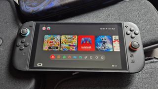 Photo by Rosalie Newcombe of the Switch 2 sitting on a pile of Switch 2 cases.
