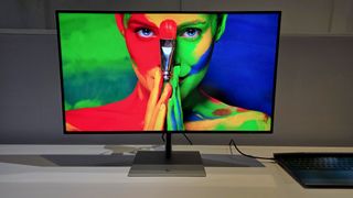 HP Series 7 Pro 4K Monitor showing a colorful image of a woman holding a brush.