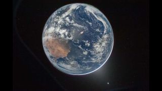a picture of a blue and white planet on a black background