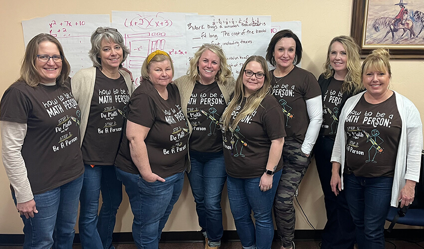 Group of educators posing for a picture in matching shirts