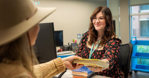 patron checkout Library staff checking out a book to a patron.