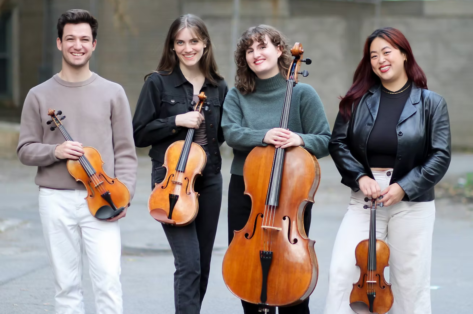 Katarina String Quartet Katarina String Quartet holding their string instruments smiling.