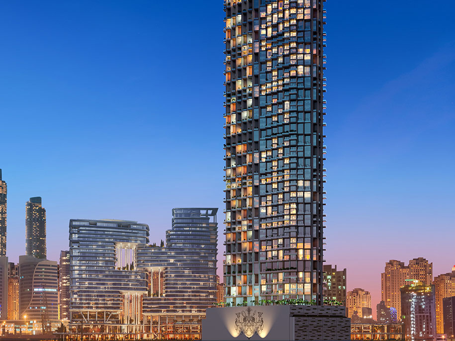 Night photo of a tall, glass exterior of SLS Puerto Madero hotel.