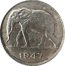 Une pièce ronde argentée avec le dessin d'un éléphant et la date 1947.