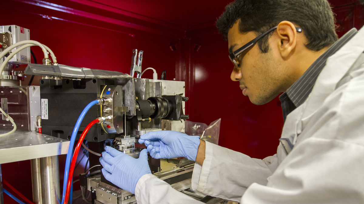 A student is working at a piece of equipment in the lab.