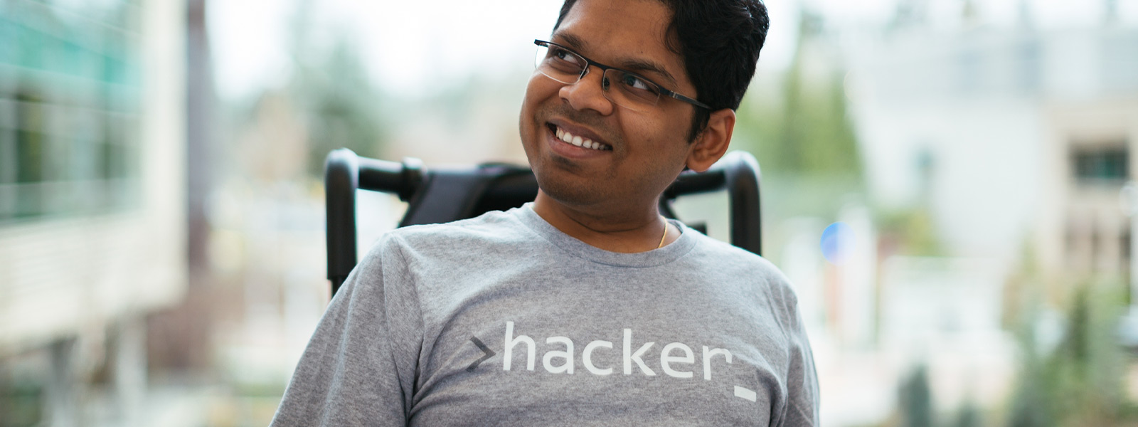 A smiling man sitting in a wheelchair