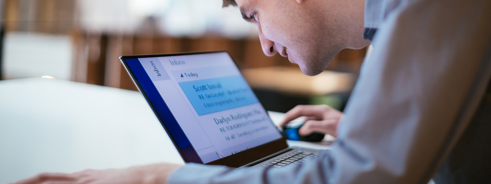 A man working on his Windows 10 computer with easy-to-read large text showing on screen