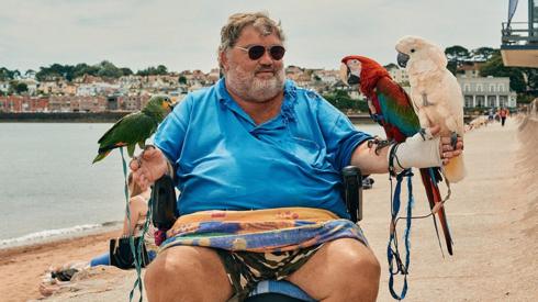 A local man takes his parrots out for a ride along Paignton Sea front
