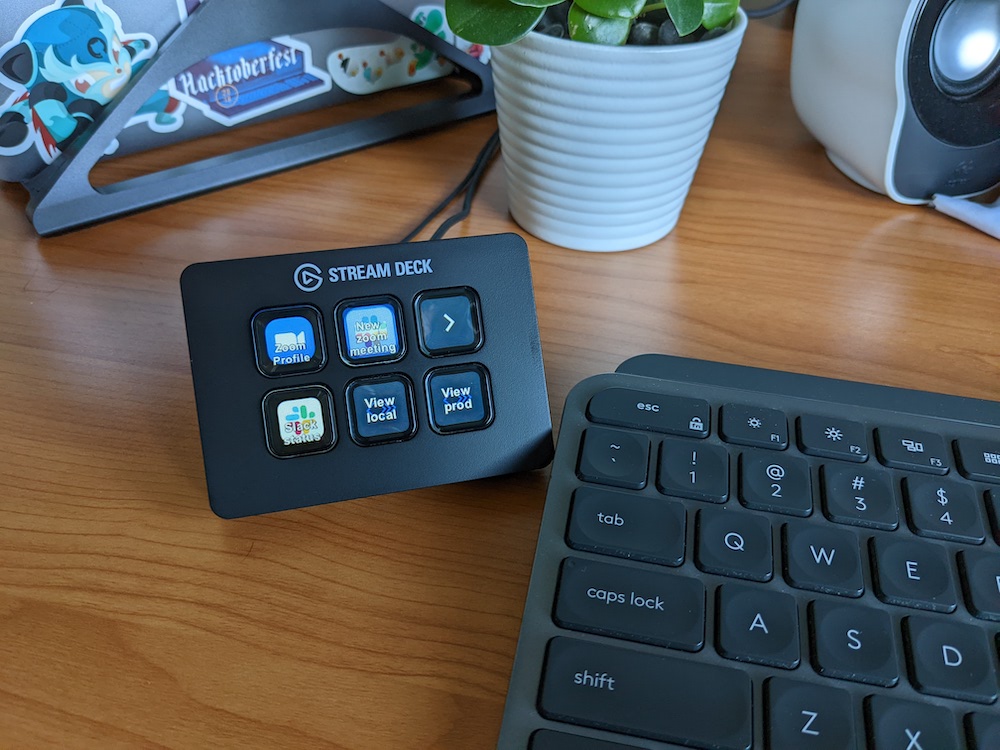 Steam deck mini on a desk next to a keyboard