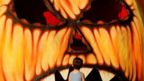 A child looks at a giant Halloween