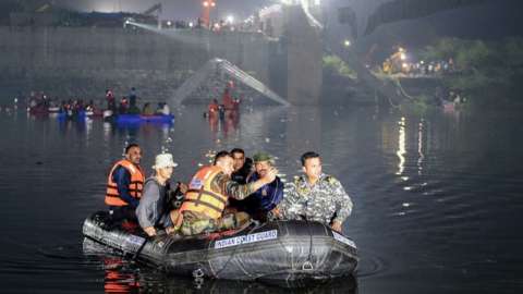 Rescuers at site of collapsed bridge in Morbi, Gujarat state, 31 Oct 22