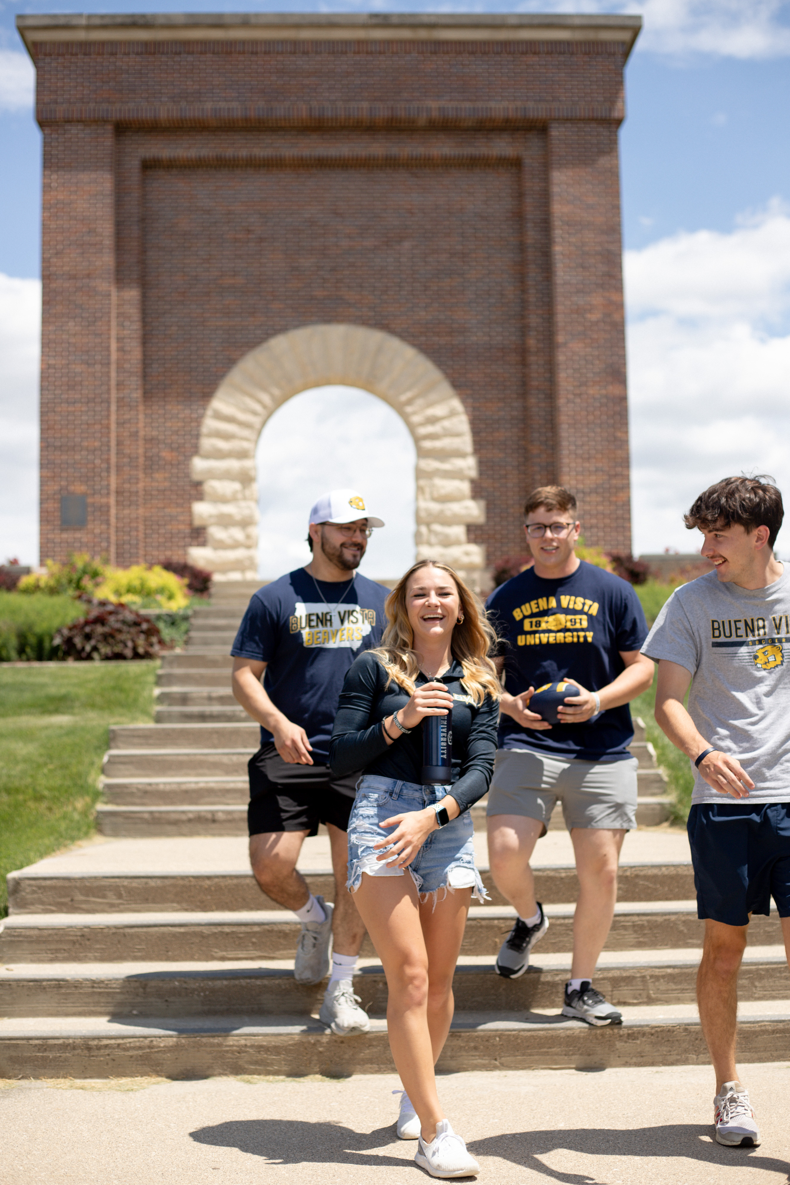 Students Walking in Front of Arch
