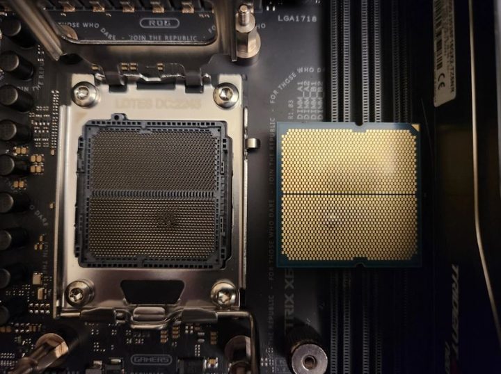 AMD Ryzen 7000 processor with a visible bulge, next to a burnt motherboard socket.