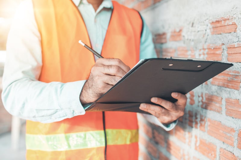 Inspection rep with clipboard and pen in hand
