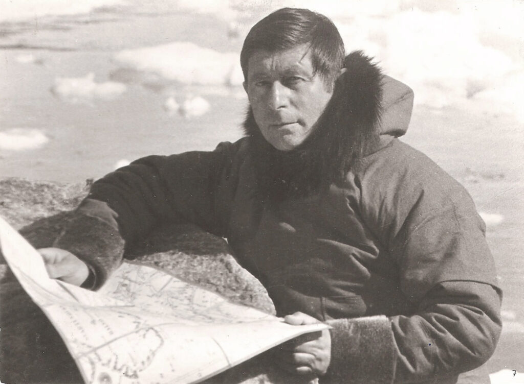 Knud Rasmussen holding a map in the Arctic