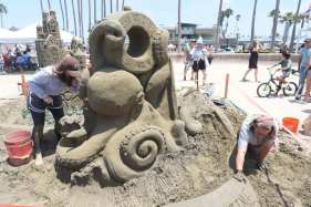 SUT-L-IB-SANDCASTLES_101 Lora Kelley, left, works on her sandcastle project with her partner during the sandcastle contest at Portwood Pier Plaza on Saturday, July 18 in Imperial Beach. (Michael Ho / For The San Diego Union-Tribune)