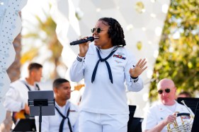 SUT-L-Navy-Band-XOL-002_554990 Ashley Pollock sings as Navy Band Southwest’s Wind Ensemble performs a free concert at Progress Park on Wednesday. (Meg McLaughlin / The San Diego Union-Tribune)
