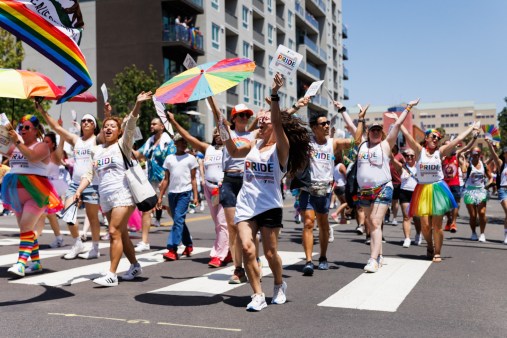 SUT-L-SD-PRIDE-017 Participants with the YMCA cheer and dance during the San Diego Pride Parade on Saturday. (Kristian Carreon / The San Diego Union-Tribune)