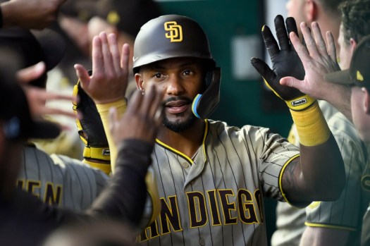 sut-l-padres-0717_0442b1 Miguel Andujar is congratulated in the Padres dugout after scoring against the Royals on Friday. (Photo by Reed Hoffmann/Getty Images)