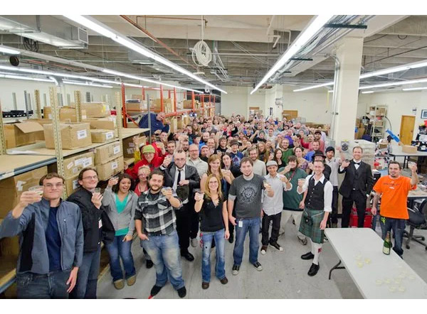 SparkFun employees toast for a picture for a Wired article.