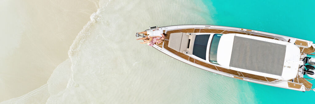 Couple lounging on a yacht at a sandbar in the Turks and Caicos.