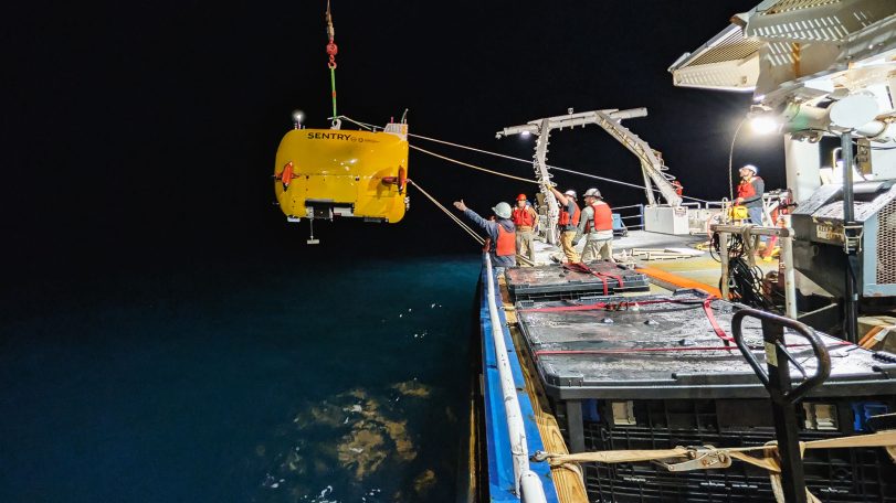 Bosun Oscar Sisson (left) and WHOI engineers Sean Kelley, Mike Skowronski, and Isaac Vandor deploy the autonomous underwater vehicle Sentry